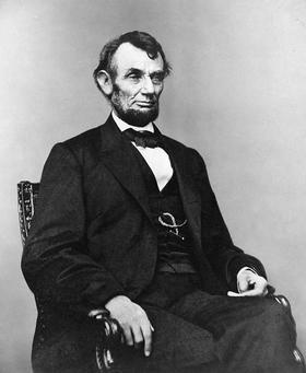 Abraham Lincoln's birthday... Ecard for them... Birthday of Abraham Lincoln. Lincoln was sitting on a chair. Free Download 2022 greeting card