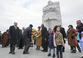 Card for guests. Many people and a statue. Free Download 2024 greeting card