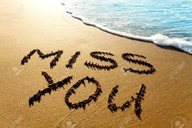 Miss You words on the send. Ecard for You. Miss you written on the beach. Free Download 2024 greeting card