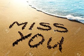 Miss You words on the send. Ecard for You. Miss you written on the beach. Free Download 2025 greeting card