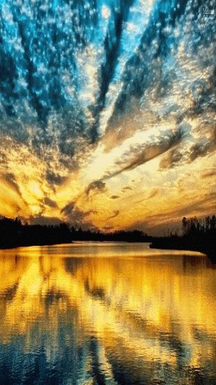 Floating clouds. Nature gif card. Reflection of a yellow blue sky in a lake. Multicolored sky. Warm weather. Calm atmosphere. Free Download 2024 greeting card